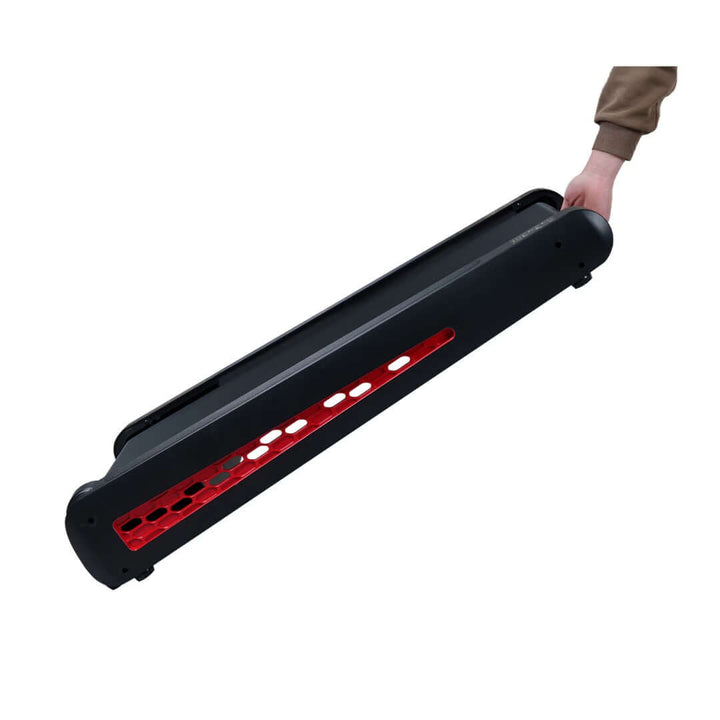 Strengthsphere Incline Walking Pad Treadmill being carried, showcasing its compact design and portability.