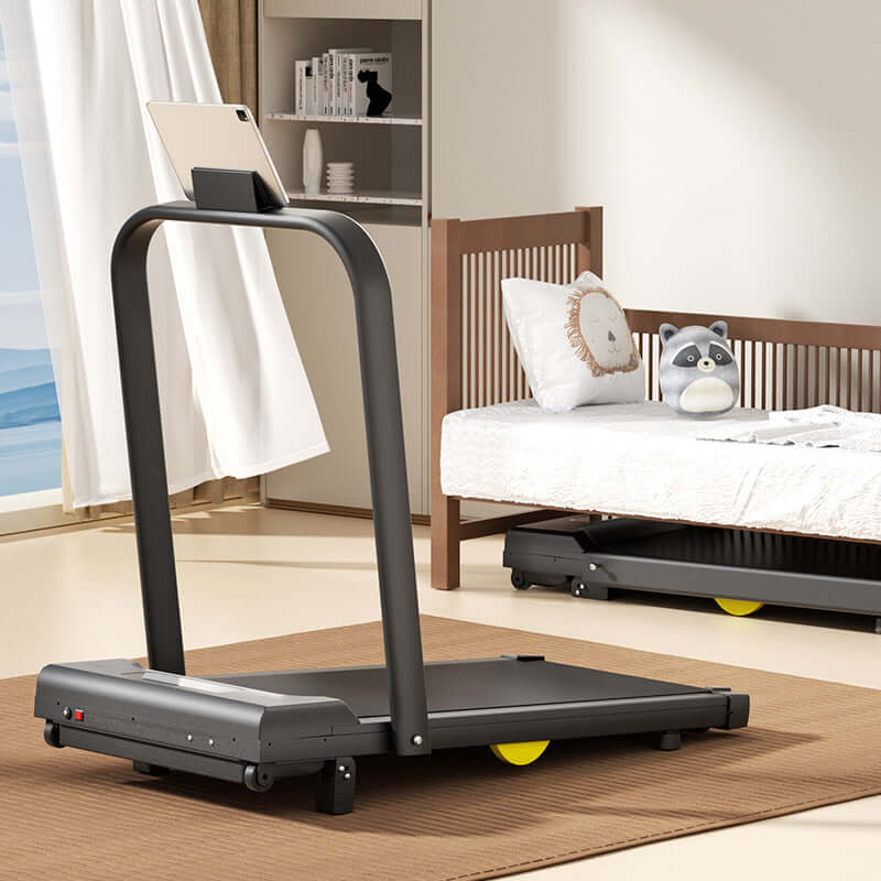 Strengthsphere Adjustable Slope Treadmill in a modern home setting with a cozy bed and tablet holder.